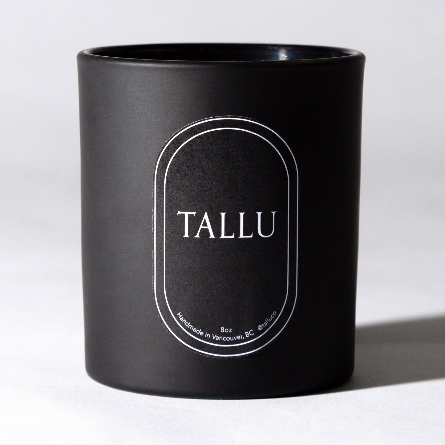 Tallu Black Votive Candle, a luxury soy candle, made with essential oils with a sleek and modern design.